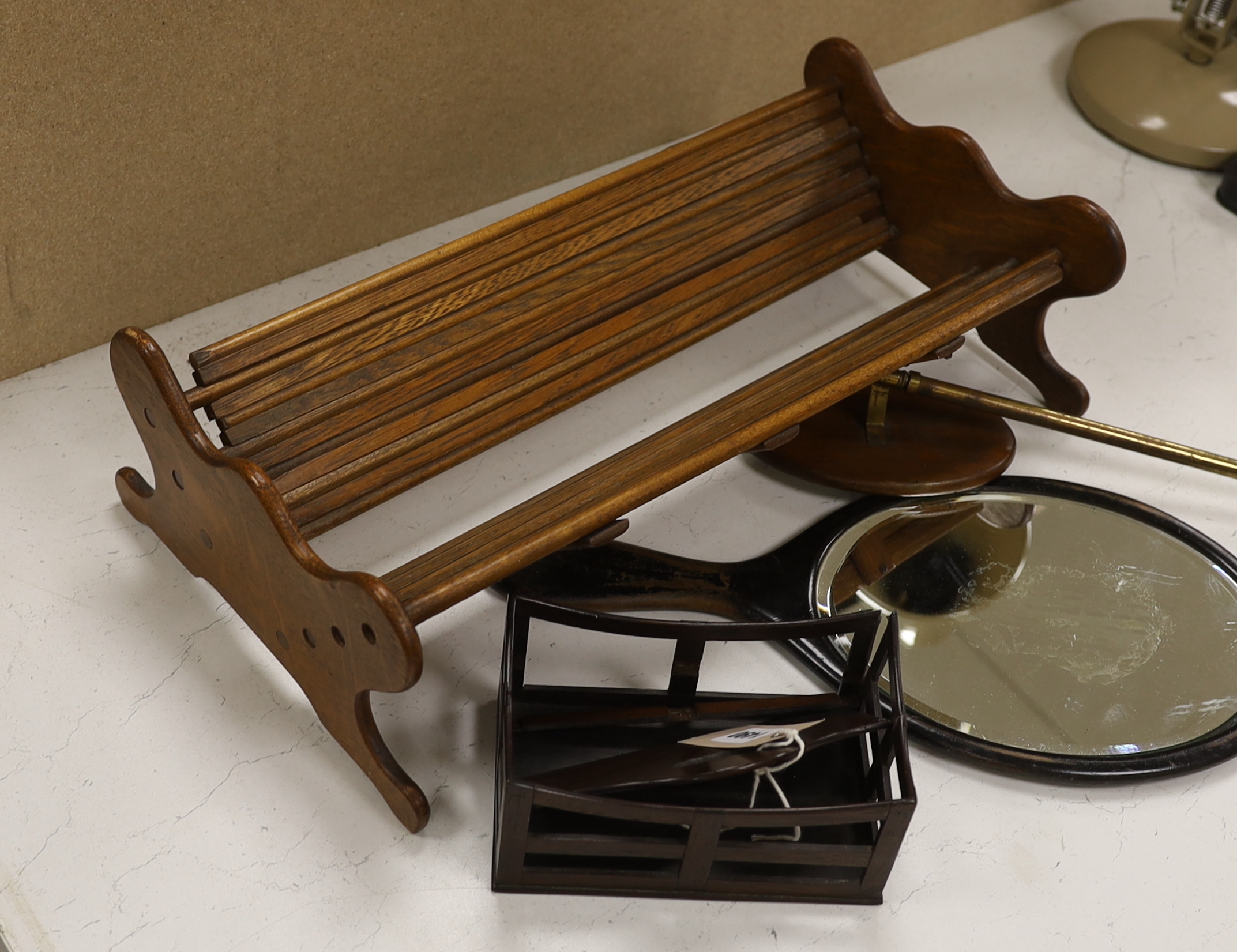 An oak book trough, a rosewood rack, a hand mirror and a telescopic hand mirror